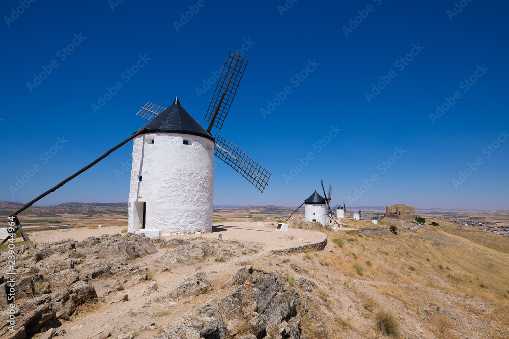 classic wind mills and ancient Castle in Consuegra town (Toledo, Castilla La Mancha, Spain). Built from the Sixteenth to the Nineteenth century. Typical from Quixote land and his book