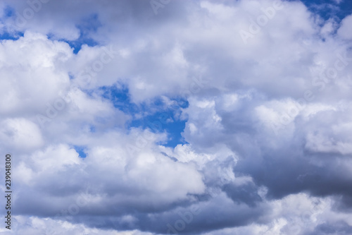grey stormy clouds on blue sky background