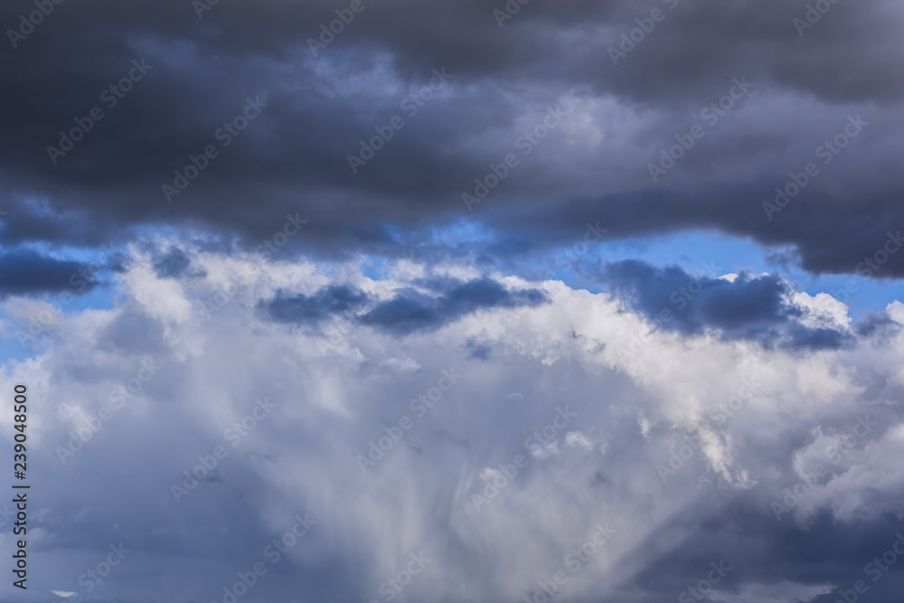 grey stormy clouds on blue sky background