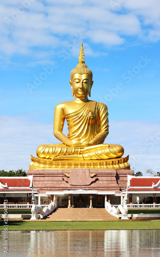 Big golden buddha status on blue sky background