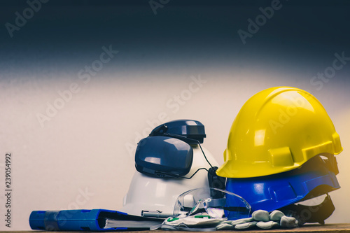 Works safety concept: PPE (Personal Protective Equipment), hard hat or industrial helmet for protection the worker from accident during working at construction site, factory or industry building.