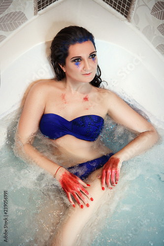 Model is posing in a bath with glitters