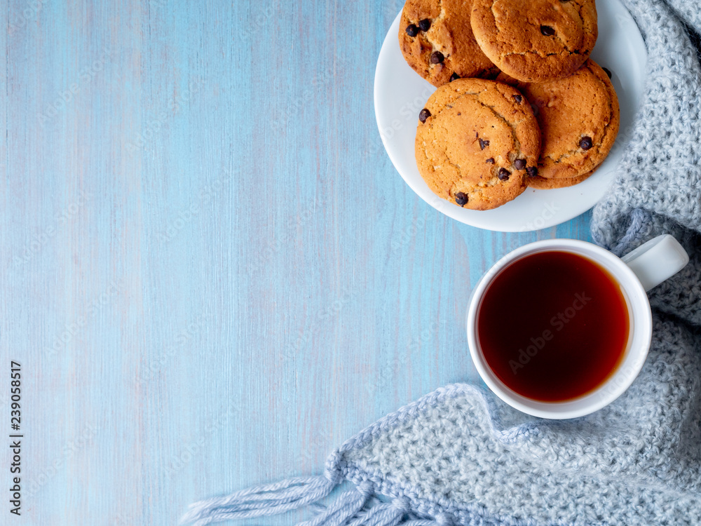 tea, teapot, copy space, warm knitted scarf on blue wooden background, cozy house, top view tea, teapot, copy space, warm knitted scarf on blue wooden background, cozy house, top view