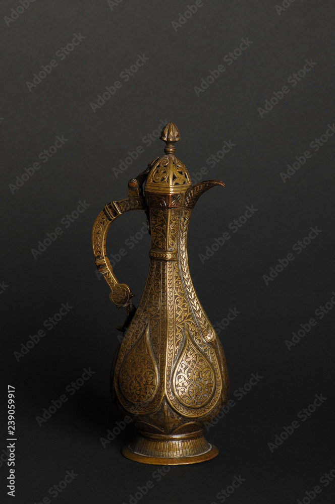 ancient oriental metal teapot on dark background. antique bronze tableware ancient oriental metal teapot on dark background. antique bronze tableware