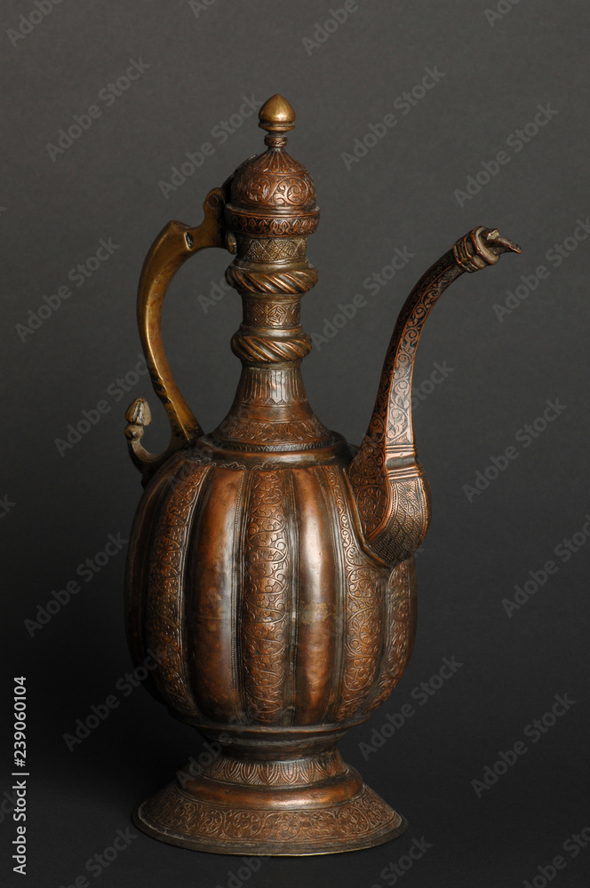 ancient oriental metal teapot on dark background. antique bronze tableware ancient oriental metal teapot on dark background. antique bronze tableware