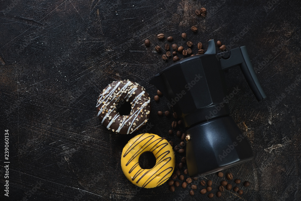 Moka coffee maker and donuts, flatlay on a dark brown stone surface, horizontal shot with copyspace Moka coffee maker and donuts, flatlay on a dark brown stone surface, horizontal shot with copyspace