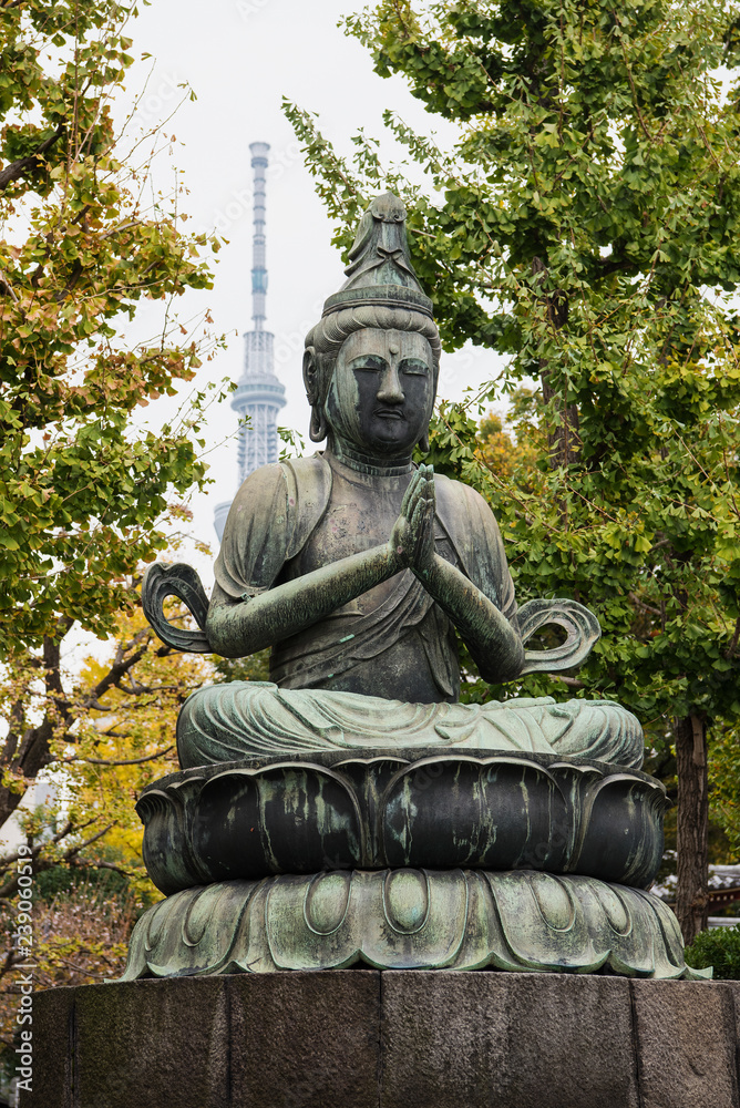Bodhisattva Kannon statue with the Tokyo Skytree in the background at Sensō-ji, Tokyo's oldest Buddhist temple
