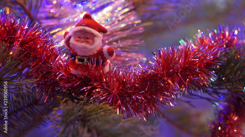 Santa Claus on the branch of the Christmas tree