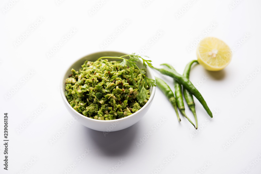 Hot and spicy green chilli chutney using hari mirch, cumin seeds, lemon juice and coriander. served in a bowl. selective focus Hot and spicy green chilli chutney using hari mirch, cumin seeds, lemon juice and coriander. served in a bowl. selective focus