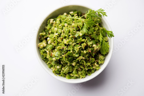 Hot and spicy green chilli chutney using hari mirch, cumin seeds, lemon juice and coriander. served in a bowl. selective focus