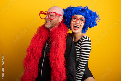 Man and woman wearing vibrant blue and red colorful outfits for portrait