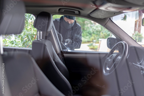 Bild auf Leinwand Einbrecher will in ein Auto einbrechen