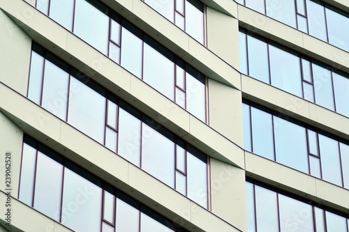 Facade fragment of a modern office building. Exterior of glass wall with abstract texture.