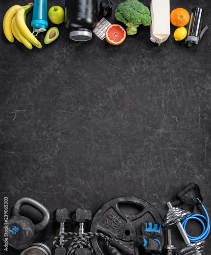 Sports equipment and organic food on a black background. Top view. Motivation