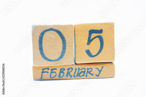February 5th. Day 5 of month, handmade wood calendar isolated on white background. Winter month, day of the year concept.