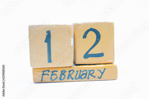 February 12th. Day 12 of month, handmade wood calendar isolated on white background. Winter month, day of the year concept.