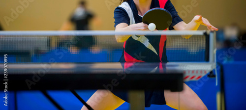 close up of a table tennis player returning photo