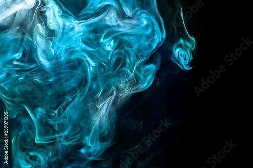 Blue cigarette smoke on black background