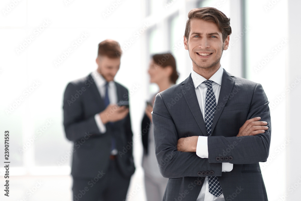 young successful businessman on background of office young successful businessman on background of office
