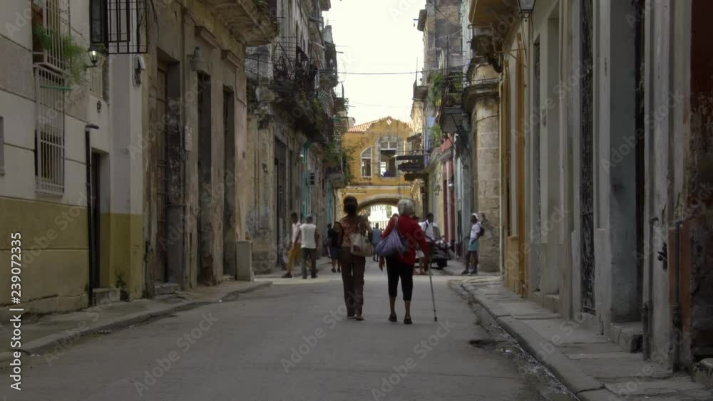 cuban senior ladies walk in a quiet neighborhood alley street in old Havana, Cuba cuban senior ladies walk in a quiet neighborhood alley street in old Havana, Cuba