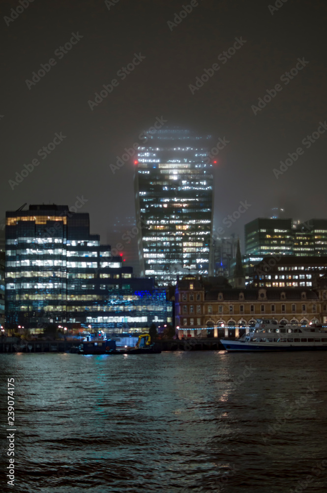 Commercial buildings on the bank of river thames in the mid of rain and snow