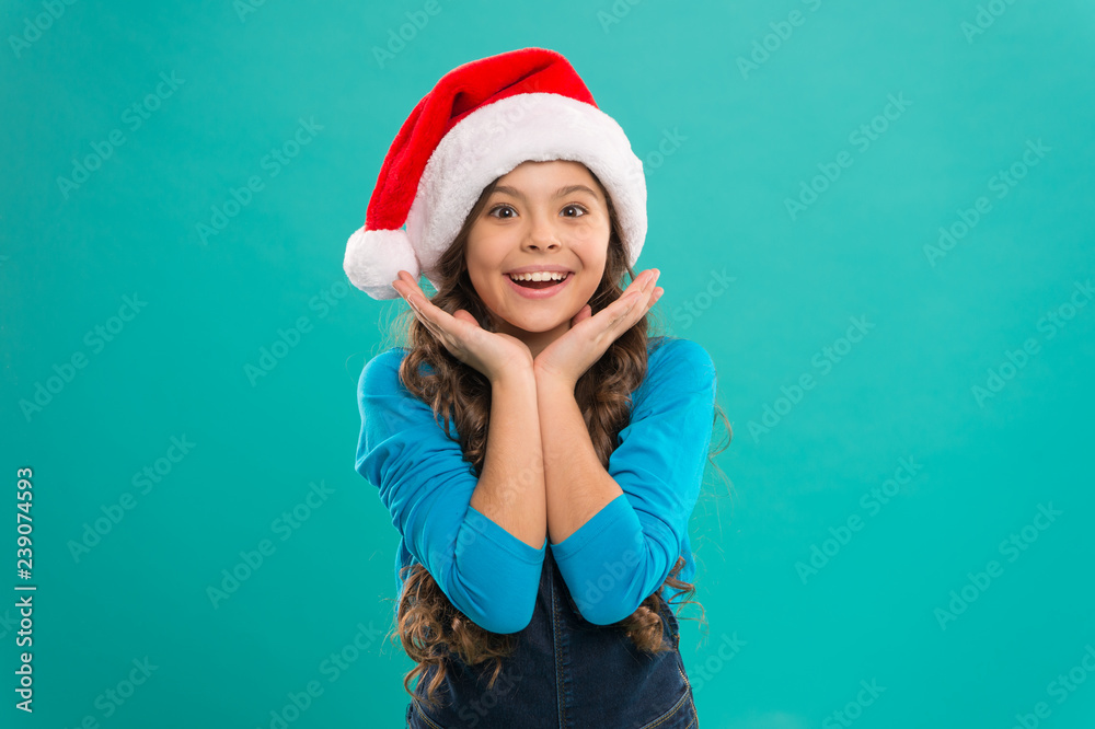 Little girl in santa hat. New year party. Santa claus kid. Happy winter holidays. Small girl. Christmas is the time to please. Present for Xmas. Childhood. Christmas shopping. Winter holidays sales Little girl in santa hat. New year party. Santa claus kid. Happy winter holidays. Small girl. Christmas is the time to please. Present for Xmas. Childhood. Christmas shopping. Winter holidays sales