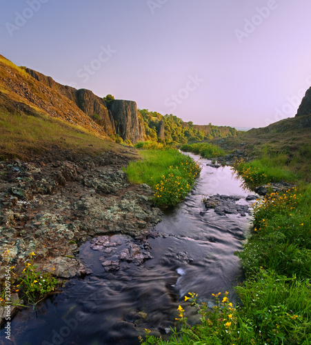 Beautiful cliffs at sunset, stream flows towards cliff: this is Phantom Falls from above, California