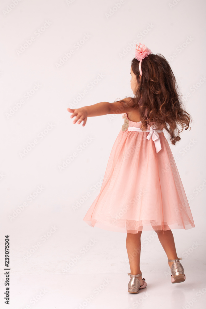 girl in an elegant pink dress and silver shoes in a white studio Stock  Photo | Adobe Stock