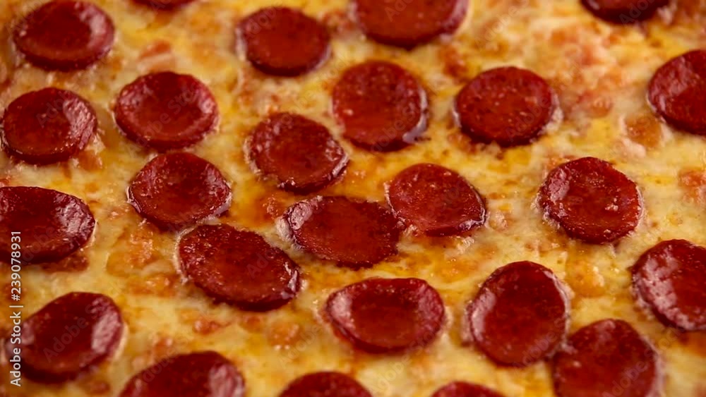 Homemade pepperoni pizza rotating. background Homemade pepperoni pizza rotating. background