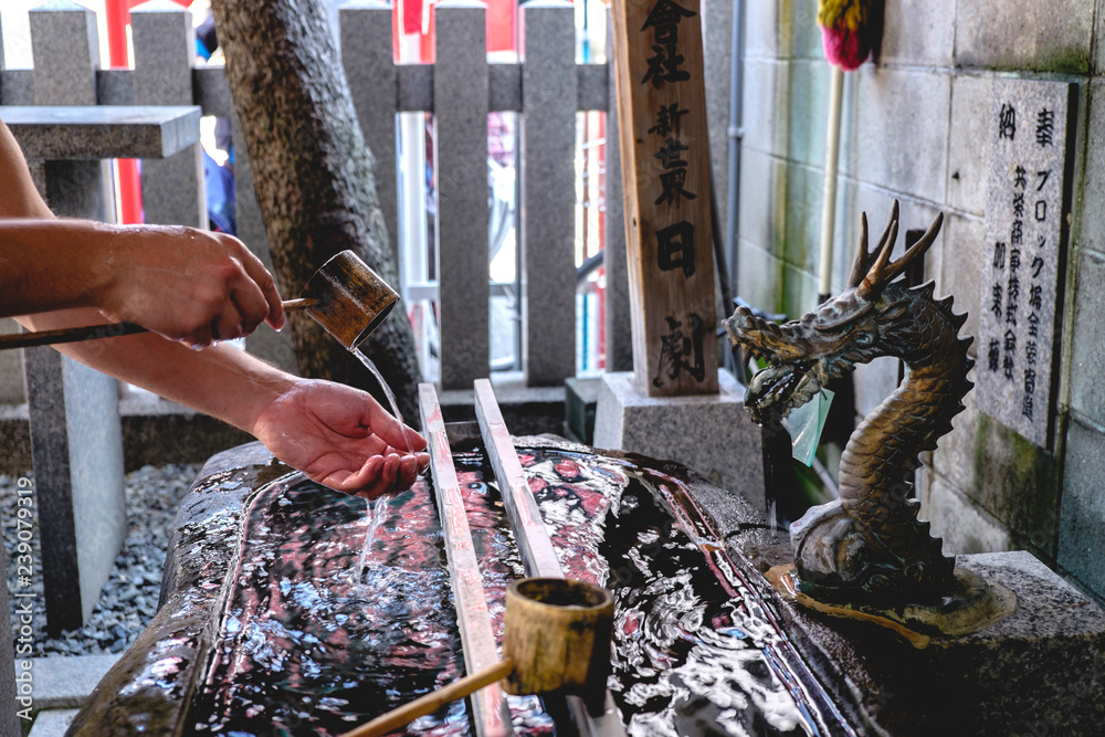 Fototapeta premium Purify hands with water at shinto shrine, Shinsekai, Osaka, Japan