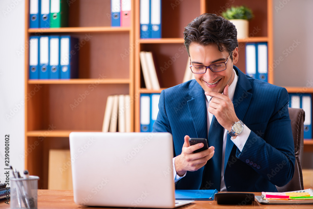 Young handsome businessman working in the office Young handsome businessman working in the office