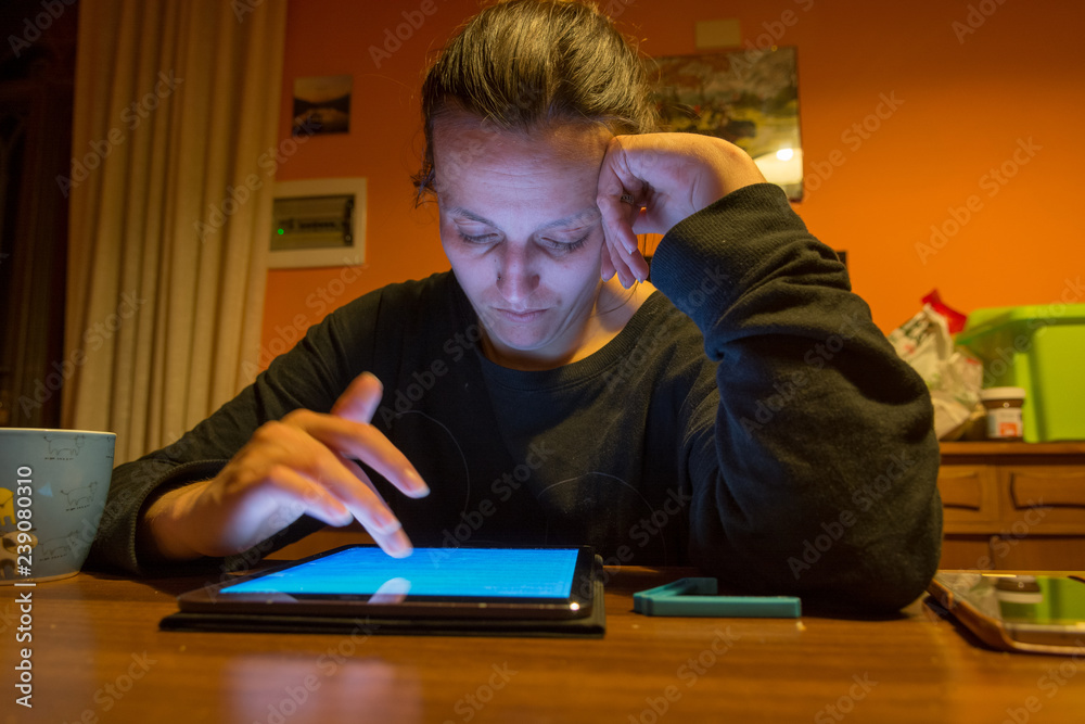 Tired mother taking some time to study on tablet. Tired mother taking some time to study on tablet.