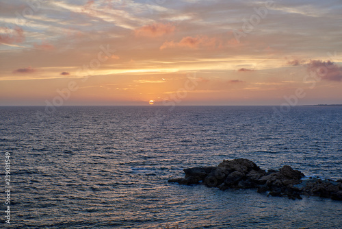 Cyprus. Kissonerga. Sunset on the coast. The sun goes down below the horizon
