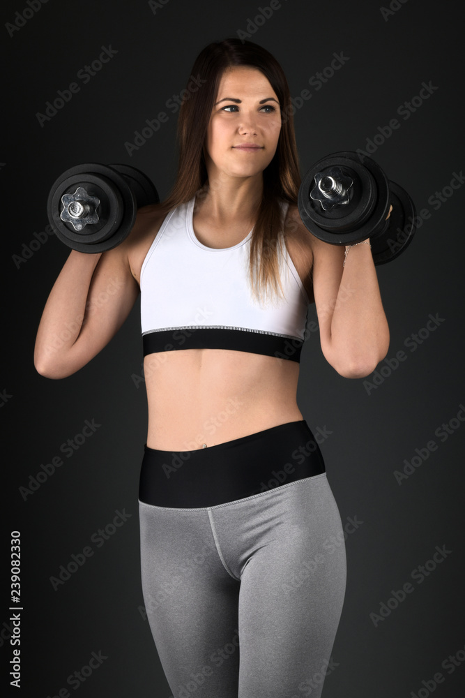 Happy young woman in sports clothing smiling