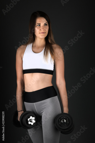 Happy young woman in sports clothing smiling