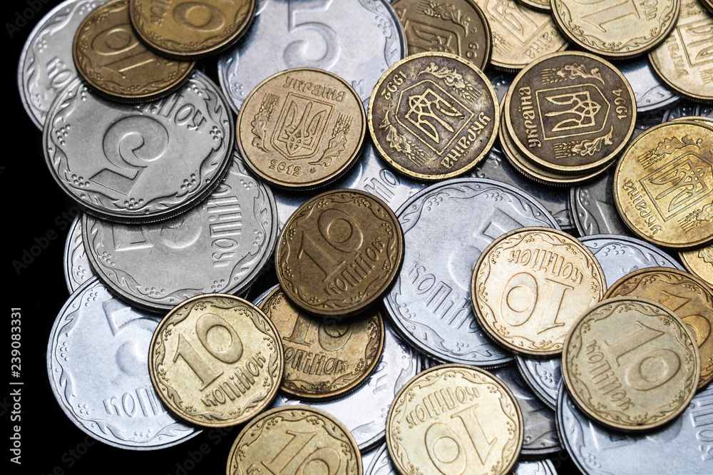 Ukrainian coins isolated on black background. Close-up view. Coins are located in the center of frame. A conceptual image. Ukrainian coins isolated on black background. Close-up view. Coins are located in the center of frame. A conceptual image.