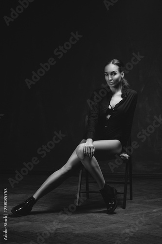 Black and white portrait of attractive brunette sexy girl. Beautiful girl posing. Young woman on black background. Studio shot