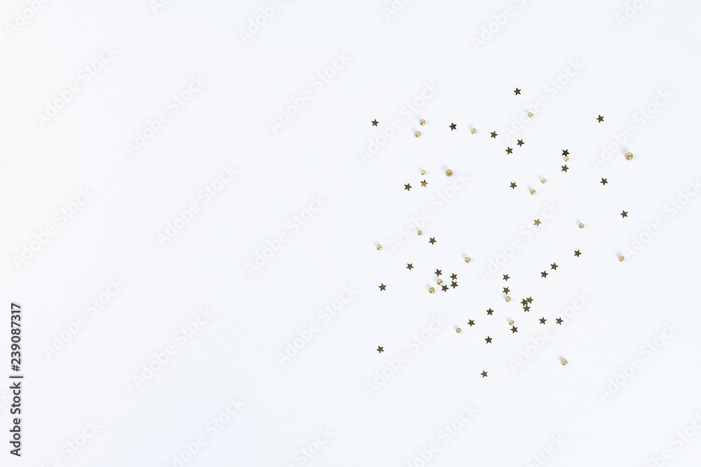 Christmas layout. Golden confetti in the form of stars on a white background. New Year 2019, christmas, winter concept. Copy space, tov view, flat lay composition. Christmas layout. Golden confetti in the form of stars on a white background. New Year 2019, christmas, winter concept. Copy space, tov view, flat lay composition.