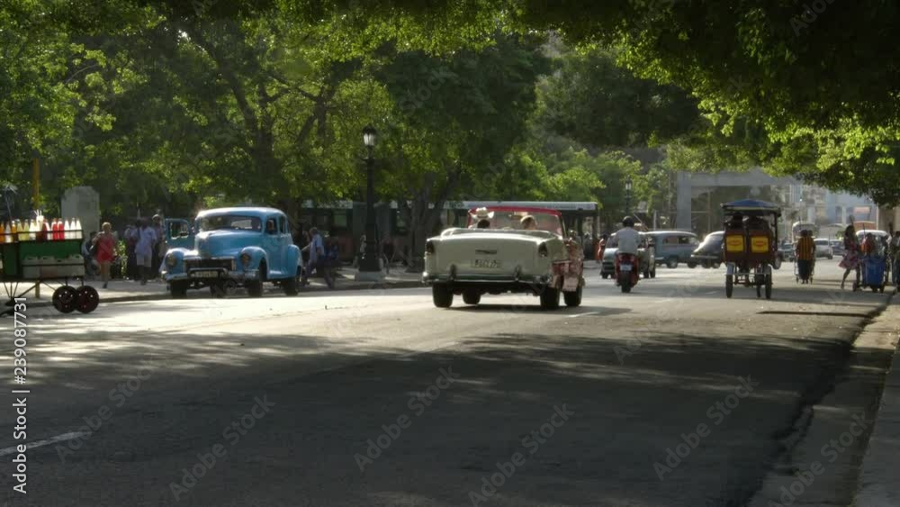 Busy everyday cuban life, old classic American 1950's vintage car taxi in Vieja neighborhood old Havana, Cuba Busy everyday cuban life, old classic American 1950's vintage car taxi in Vieja neighborhood old Havana, Cuba
