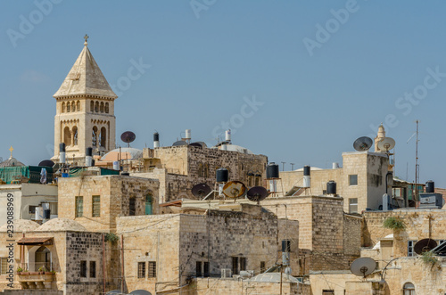 The bell tower of the Lutheran Church of the Redeemer towering over rooftops in the Old City of Jerusalem, Israel