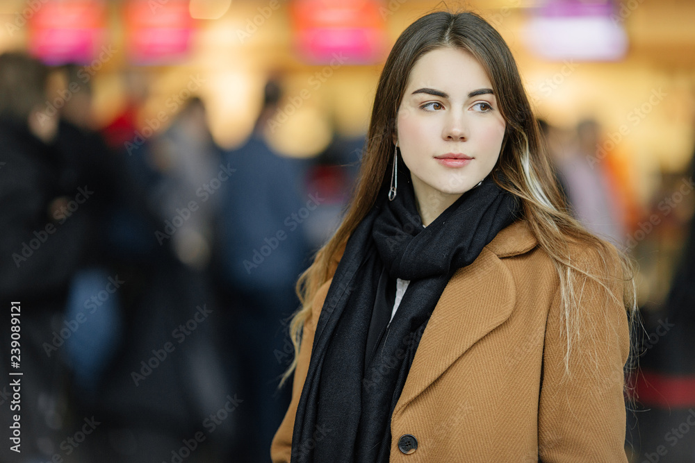 Portrait of pretty girl standing on the airport and wait for her flight. Copy space