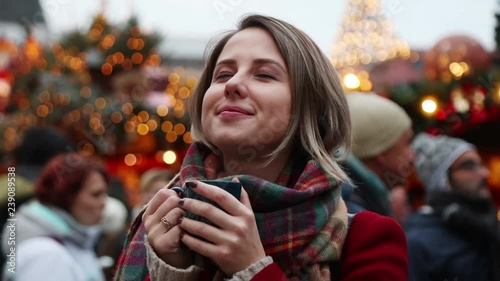 Young girl with cup of hot drink on Christmas fair in Dresden, Germany