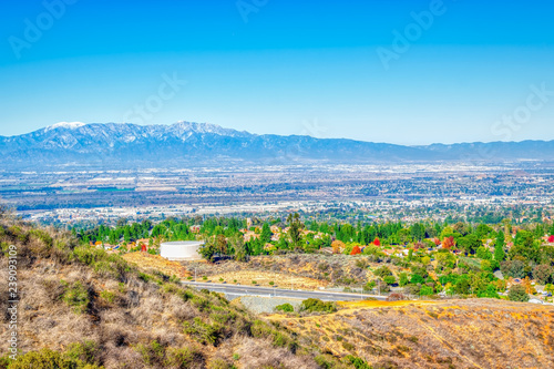 Winter afternoon on inland empire with colorful trees and snow top mountains