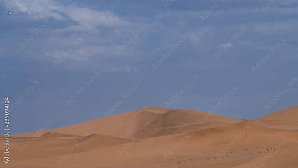 Sand dunes and desert under blue sky at Mingsha Mountain, in Dunhuang, Gansu, China Sand dunes and desert under blue sky at Mingsha Mountain, in Dunhuang, Gansu, China
