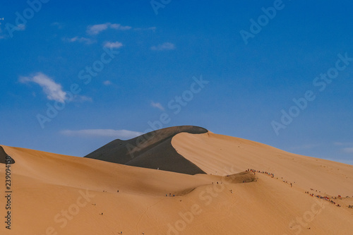 Sand dunes and desert under blue sky at Mingsha Mountain  in Dunhuang  Gansu  China