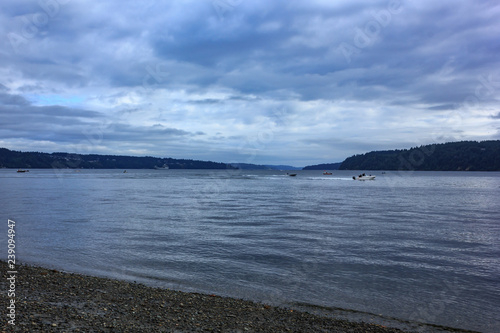 summer clouds cover speed boats and fisihing boats photo