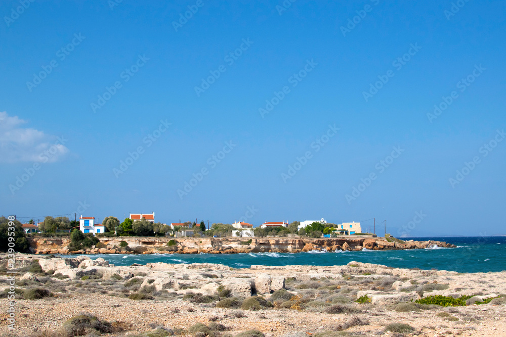 The houses of the locals of the island of Aegina in the Mediterranean Sea near Athens. The coastline of the island with the architecture of the local population, residential buildings