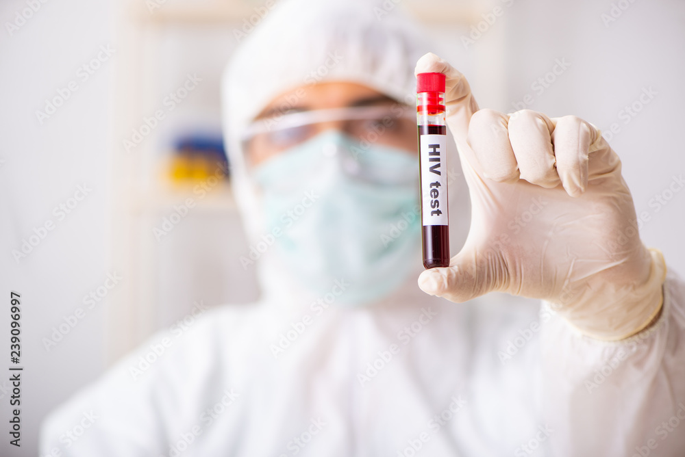 Young handsome lab assistant testing blood samples in hospital 