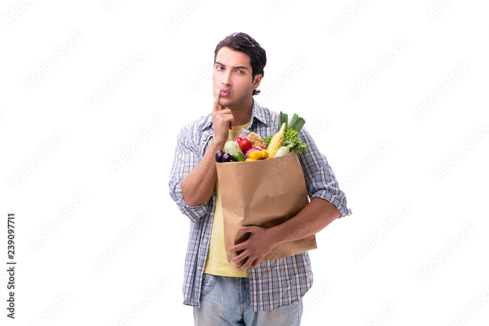 Young man with his grocery shopping on white Young man with his grocery shopping on white
