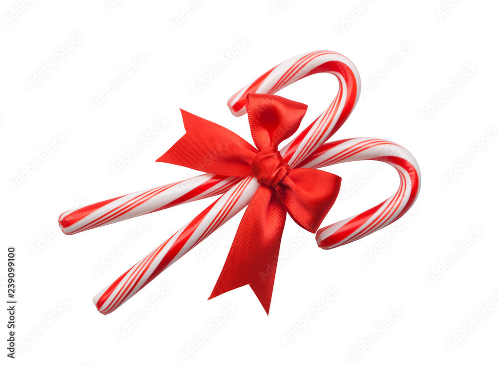 Candy canes with red bow isolated on white background Candy canes with red bow isolated on white background